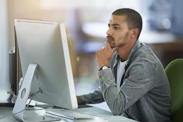 Online distance education student looking at large computer screen.